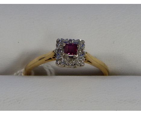 A small square ruby and diamond Ring, the central ruby surrounded by eight small diamonds mounted in silver and 18ct yellow g