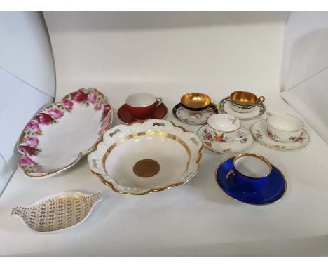 A collection of German porcelain items to include; two Rosenthal cups and saucers, two internally gold painted cups and sauce
