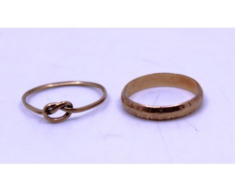 9ct Gold Wedding Band and 9ct Gold Knot Ring.   They are both hallmarked "375" for 9ct Gold.  The 9ct Gold Wedding Band size 