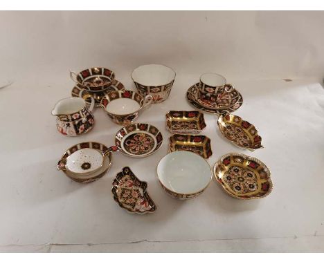 A collection of Royal Crown Derby English bone china, Imari pattern pieces to include; various pin dishes, cups and saucers, 