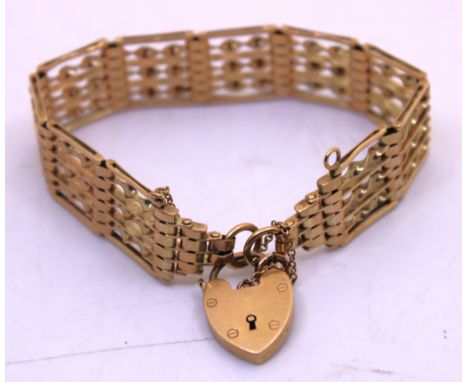 9ct Yellow Gold Gate Bracelet with Padlock & Safety Chain.  The width of the bracelet is approx. 15mm.  The bracelet is hallm