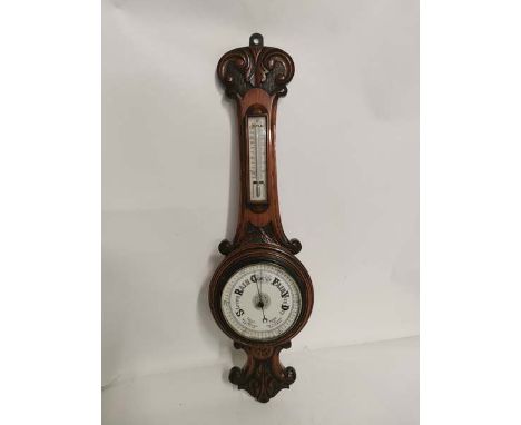 A carved oak cased aneroid barometer circa 1900. 74cm high. In good condition. (1)