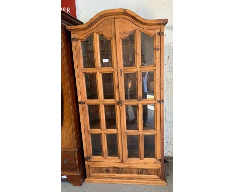 Modern Mexican pine display cabinet with glazed panel doors