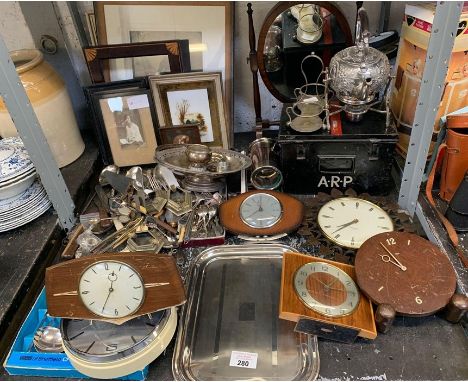 Shelf of collectables including mantle clocks, cutlery &amp; an ARP black tin box