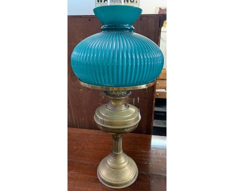 Brass oil lamp with ribbed green shade