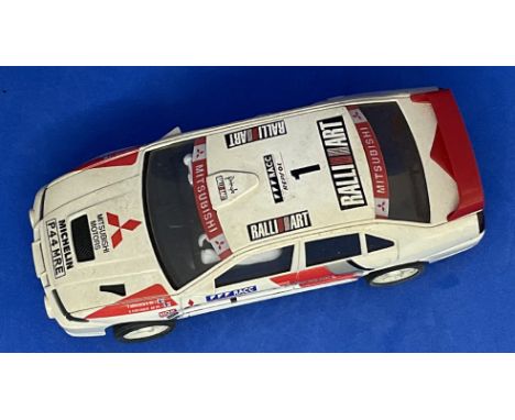 Mitsubishi Lancer EVO IV 1:32 Scalextric slot racing car unboxed with some ageing fair, good condition. We combine postage on