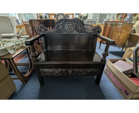 Small Monks Bench, with hinged seat, carved back rest, front and sides.  Height 35'', width 35'', depth 18''.