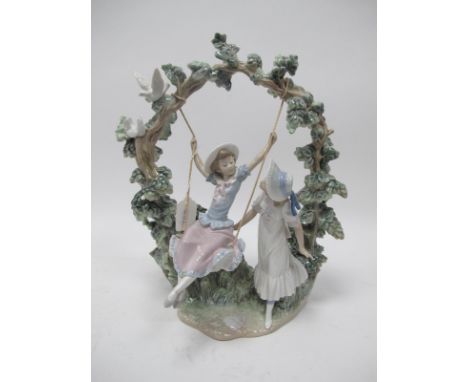 A Lladro Figure Group of a Girl on a Swing with Onlooking Friend, number F-160, 38cm high.Lot 1085 - good condition