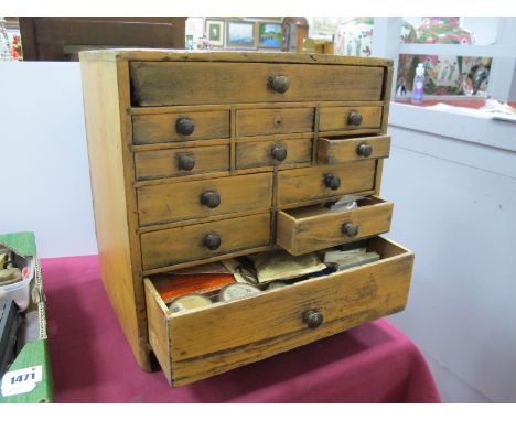 A Late XIX Century Pine Miniature Chest of Drawers, each with twelve assorted drawers containing a variety of watch/clock mak