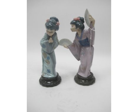 Two Lladro Japanese Geisha Figures, one with fans, 29.5cm high, the other praying. (2).
