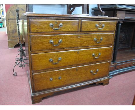 An Early XIX Century Oak Chest of Drawers, the top with moulded edge over two short and three long drawers on bracket feet, 7