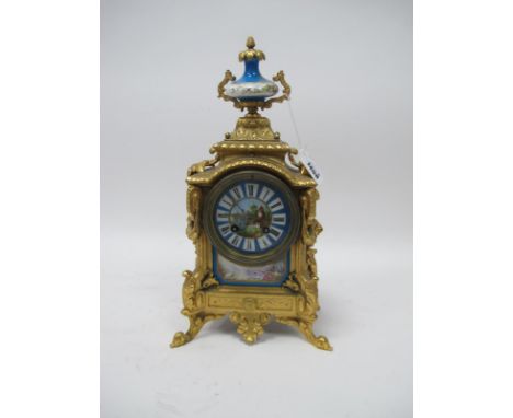 A Late XIX Century French Ormolu Mantle Clock, of roccoco form, the rectangular body with floral swags to the sides and laure