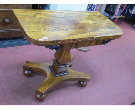 A XIX Century Rosewood Card Table, the fold-over top with baized interior, raised on bulbous and block pedestal and quatrefoi