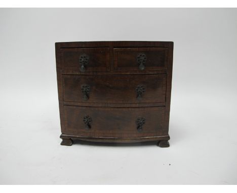 An XVIII Century Style Miniature Bow Fronted Chest of Drawers, of two short and two long drawers raised on bracket feet, 18.5