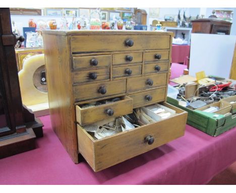 A Late XIX Century Pine Miniature Chest of Drawers, each with twelve assorted drawers containing a variety of watch/clock mak