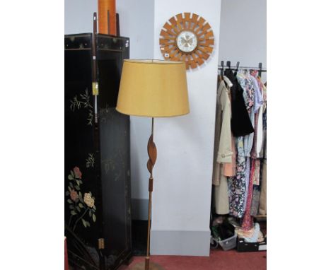 A Bentima Battery Wall Clock, with teak wheel surround, 41cm diameter; together with a brass tubular standard lamp, with teak