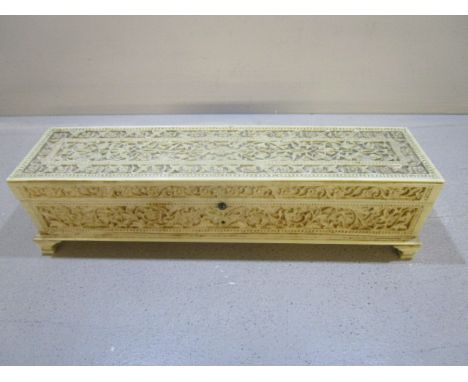 A 19th century European carved ivory box decorated with continuous bands and panels of flower heads, scrolled and entwined le
