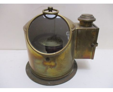 An R & D Slimon brass cased binnacle mount compass with a ring handle and side door, the dial inscribed No 87218, 9 h