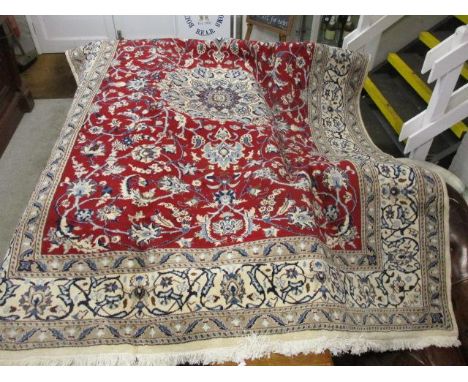 A Persian Casson carpet with a central medallion, entwined vines and boteh on a red ground, 117 x 78