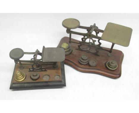 B.W.B.W. early C20th brass postage scales on shaped and moulded mahogany base with matched weights W24cm and smaller scales W