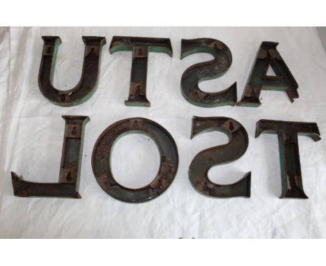 Collection of eight green enamel metal letters, A, L, O, S(2), T(2), U 