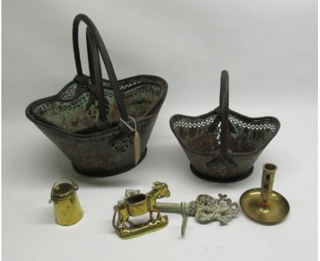 Graduated set of three pierced distressed metal lozenge shaped baskets with twist handles, brass candlestick, churn, match ho