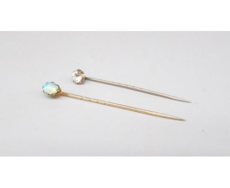 Yellow metal tie pin set with cabochon opal, stamped 240, 1.7g, and a white metal tie pin set with clear stone 