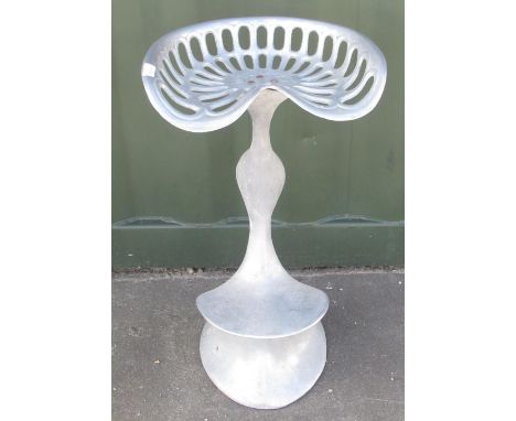 Cast metal bar stool with tractor seat top, stamped Watts 