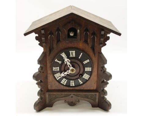 C20th Black Forest oak mantle clock, carved and shaped case with applied mouldings, unsigned two train movement striking on a