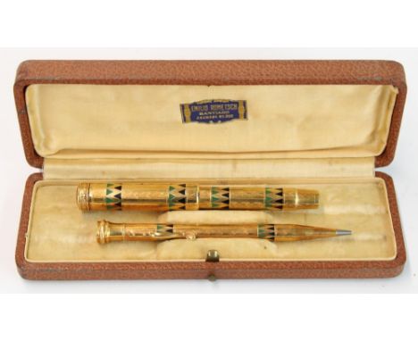 Parker Duofold fountain pen and mechanical pencil pair, the bodies decorated in engraved Aztec geometric designs with green a