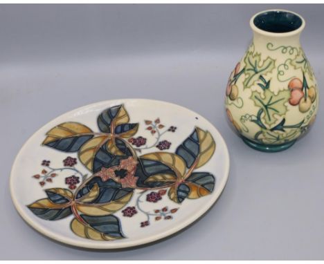 Moorcroft Pottery: small tapering baluster form vase, dated 1996, decorated with foliage and berries against a light yellow t