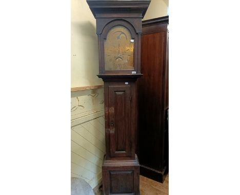 A longcase clock, with a brass dial, subsidiary date and seconds dial, and a painted moon phase dial, in an oak case, in need
