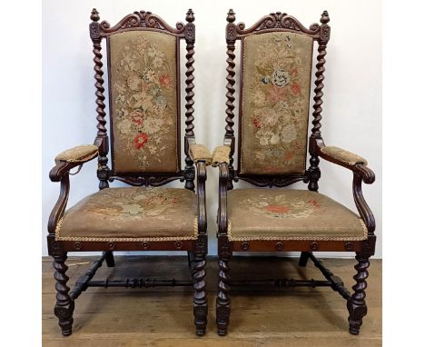 A pair of 19th century walnut high back armchairs, with carved top rails, spiral turned supports to tapestry backs, arms and 
