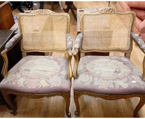 A pair of gilt armchairs, with reeded backs, tapestry padded arms and seats and cabriole front legs (2)