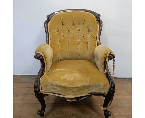 A 19th century walnut framed button back armchair