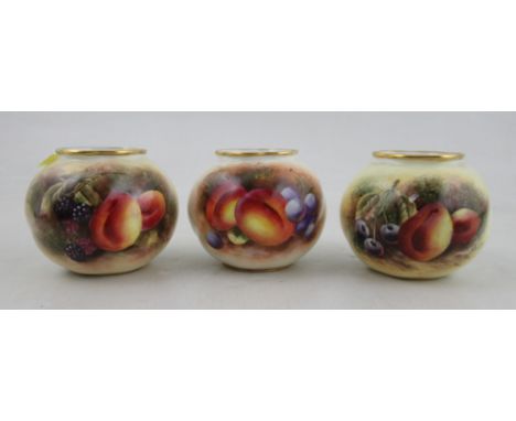 A pair of Royal Worcester vases, decorated to the front with fruit to a mossy background by Bowkett, together with another de