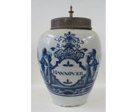 An 18th century Dutch faience pottery jar, decorated in blue and white with two Native Americans smoking a pipe either side, 