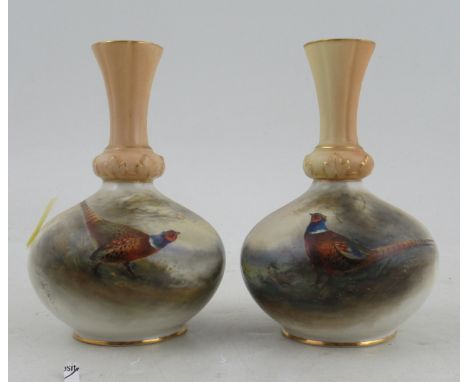 A pair of Royal Worcester vases, with blush ivory necks, decorated with pheasants in landscape by Jas Stinton, shape number G