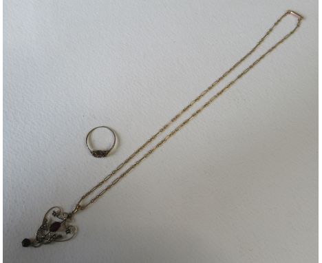 A 9ct open work pendant, set red paste and seed pearls on a 9ct chain, together with a ring, set garnet cluster, weight 6.5g 