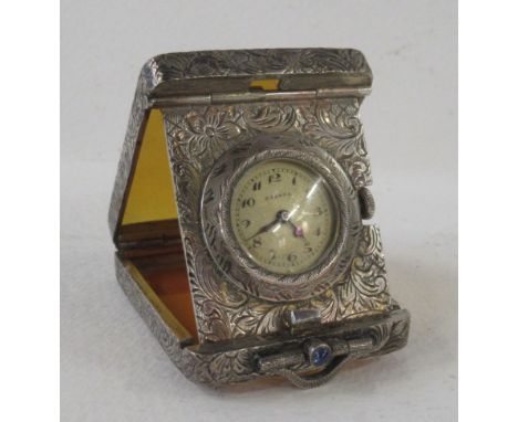 An Eterna travelling clock, in silver and orange plastic, marked 935