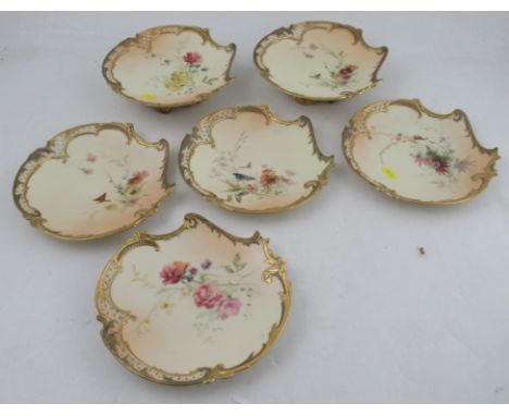 Four Royal Worcester blush ivory plates, and a pair of low comports, all decorated with floral sprays, monogrammed for Edward
