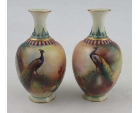 A pair of Royal Worcester Hadley Ware vases, decorated all around with peacock in a pine tree, height 4.25ins