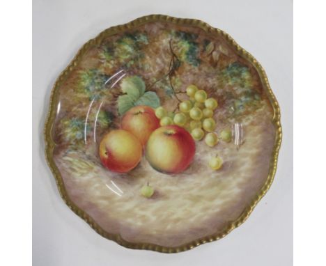 A Royal Worcester cabinet plate, decorated with fruit to a mossy background by G Banks, with shaped gilt edge, diameter 9.25i