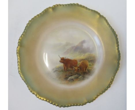A Royal Worcester plate, decorated with two Highland cattle in a glen by J Stinton, to a shaded green boarder, diameter 10ins