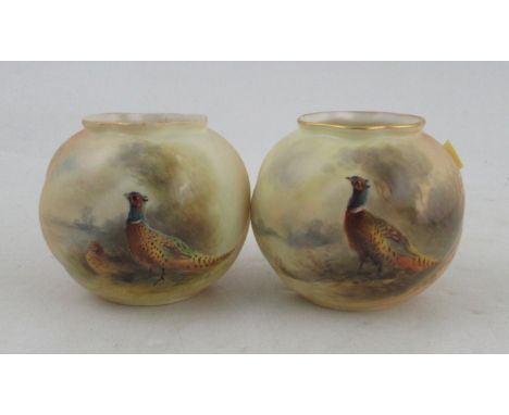 Two Royal Worcester blush ivory vases, decorated with pheasants in landscape by Jas Stinton, shape number G161, height 3ins