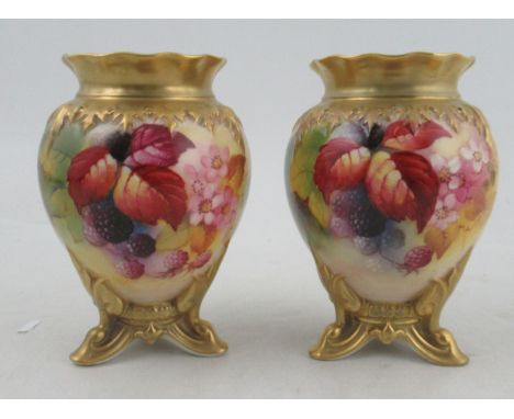 A pair of Royal Worcester vases, decorated with autumnal leaves, flowers and fruit by Kitty Blake, shape numbers H245, lackin