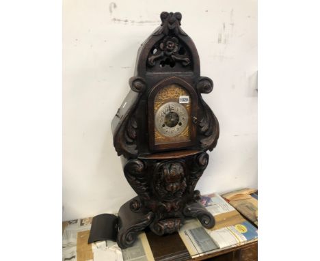 A VICTORIAN MANTEL CLOCK IN ELABORATE CARVED OAK CASE 