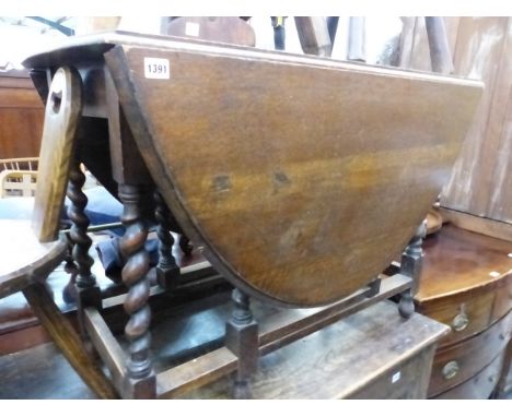 A OAK BARLEY TWIST GATE LEG TABLE. H 72 W 99 D 57cms 