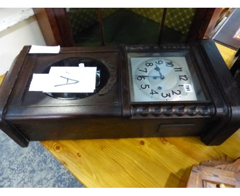 AN OAK CASED WALL CLOCK