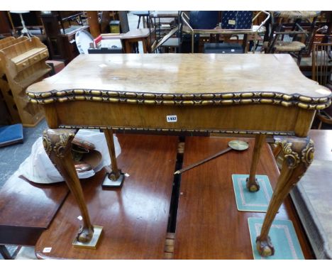 AN EARLY 20th CENTURY WALNUT FOLD OVER CARD TABLE ON CLAW AND BALL FEET
